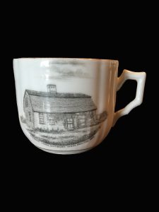 Tea cup with image of saltbox house in black and white