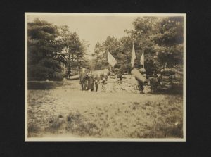 Group of people standing in graveyard with cannons.
